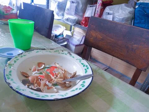 The dining table is in a mess. A messy dining table with used dishes and full Stock Photos