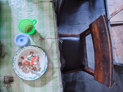 The dining table is in a mess. A messy dining table with used dishes and full Stock Photos