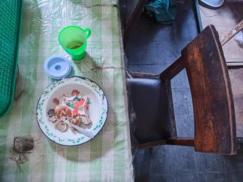 The dining table is in a mess. A messy dining table with used dishes and full Stock Photos