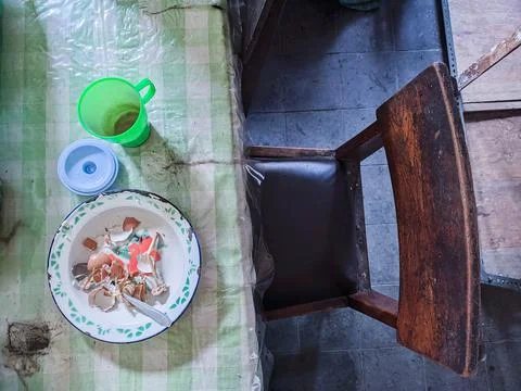 The dining table is in a mess. A messy dining table with used dishes and full Stock Photos