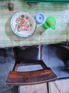 The dining table is in a mess. A messy dining table with used dishes and full Stock Photos