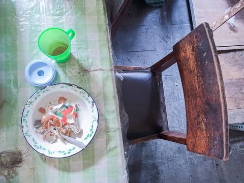 The dining table is in a mess. A messy dining table with used dishes and full Stock Photos