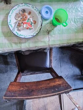 The dining table is in a mess. A messy dining table with used dishes and full Stock Photos