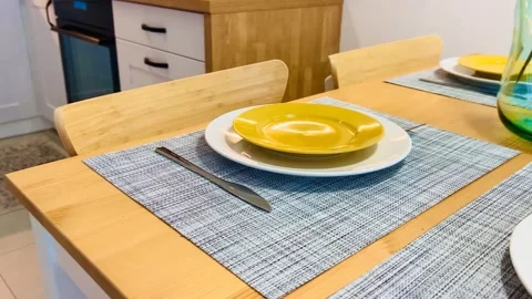 Dining table with plates and cutlery, closeup Stock Footage 259900367