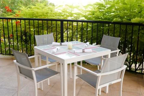 Dining table set up in open terrace with beautiful nature view Stock Photos