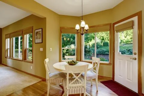 Dining table set with round counter top and stripped chairs Stock Photos