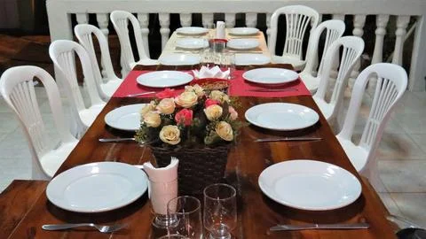 Dining table set on rustic wood and plastic chairs Stock Photos