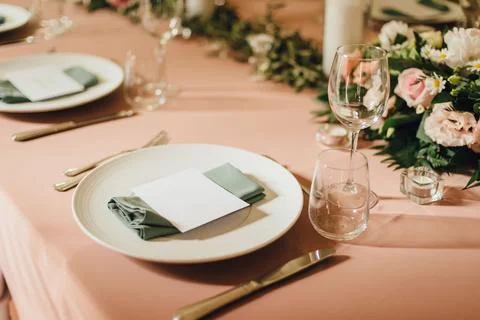 A dining table set up for two with place settings and cutlers Stock Photos