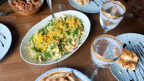 The dining table is set with various delicious dishes and salads. Stock Footage 235615518