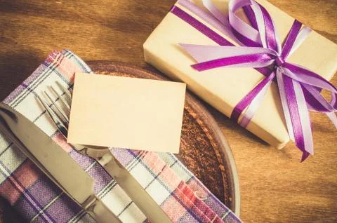 Dining Table Setting with Empty Tag and Present. Stock Photos