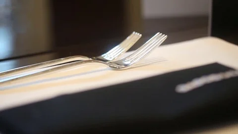 Dining table setting macro close up forks Stock Footage 77604684