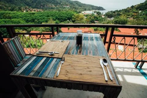 Dining table setting in summer open air cafe. Wooden furniture in a summer cafe Stock Photos
