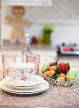 Dining table setup and modern kitchen view Stock Photos