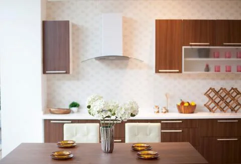 Dining table setup and modern kitchen view Stock Photos