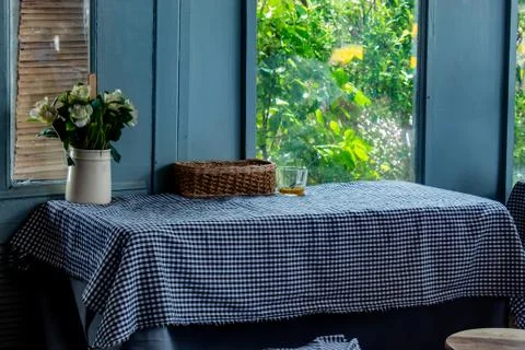 The dining table, tablecloth and put a vase of flowers. Stock Photos