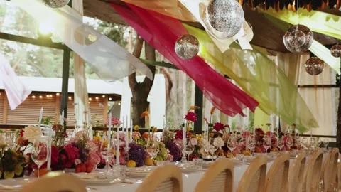 Dining table on the terrace in the restaurant, decorated with flowers, candles Stock Footage 324677275