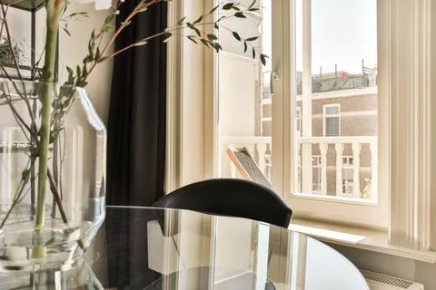 A dining table with a view of a window Stock Photos