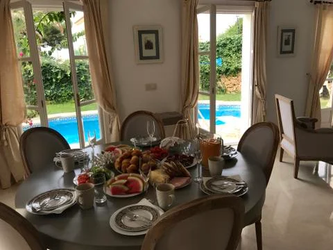 Dining table waiting for guests Stock Photos