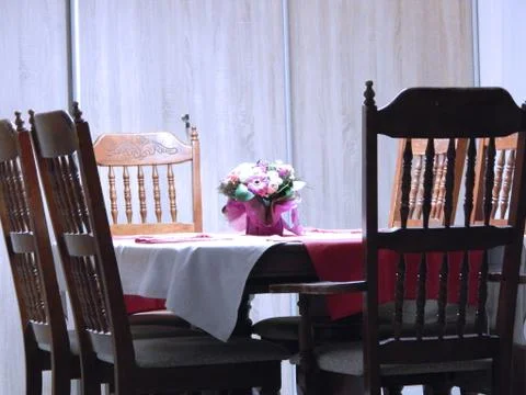 Dining table on which there is a bouquet of flowers Stock Photos