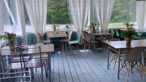 Dining table with wooden chairs set for dinner on the terrace Stock Footage 269152170