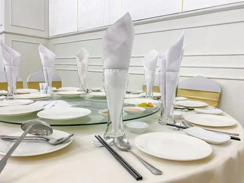 Dinner banquet table setting and elegant tableware in wedding hall Stock Photos