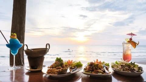 Dinner during sunset with fish and thai food Stock Photos