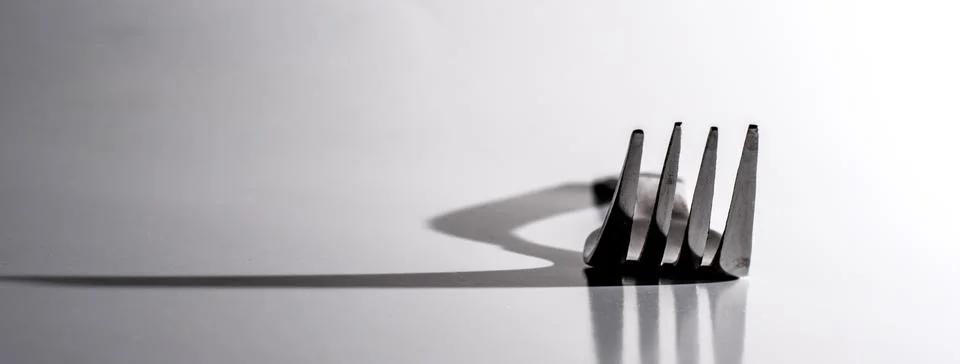 Dinner Fork throws large Shadow Stock Photos