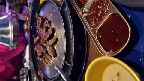 Dinner at a Korean restaurant. Cooking beef. Barbecue Stock Footage 262969054
