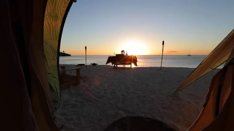Dinner luxury table set on the sunset beach with torches and red cloth. Stock Footage 202120715