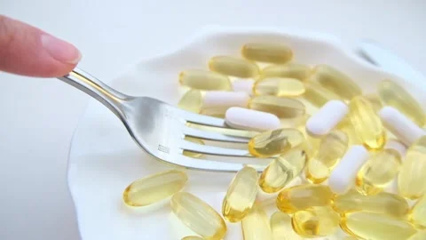 Dinner of pills with a fork. The concept of losing weight with pills or regular Stock Footage 225613351
