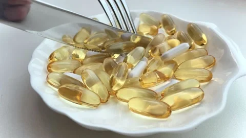 Dinner of pills with a knife and fork. The concept of losing weight with pills Stock Footage 224108222