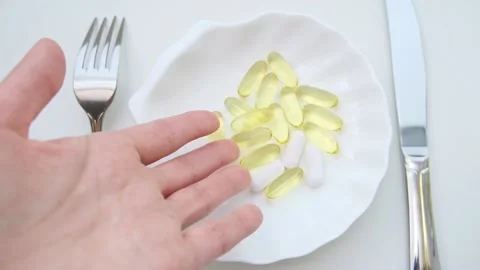 Dinner of pills with a knife and fork. The concept of losing weight with pills Stock-Footage 225613234
