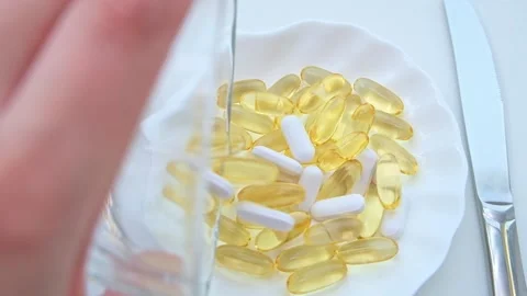 Dinner of pills with a knife and fork. The concept of losing weight with pills Stock Footage 225613277