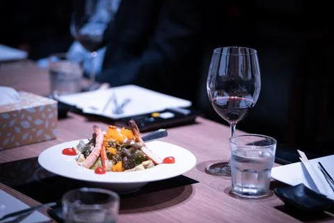 Dinner is placed on the dining table in a fine dining restaurant Stock Photos