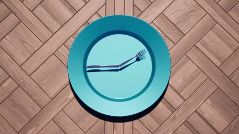 A dinner plate clock with knife and fork hands, 12-hour time-lapse. Stock Footage 327462235