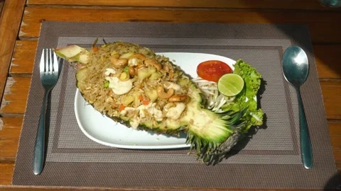 Dinner plate placed on the table. Fried rice with chicken served in pineapple Stock Footage 237745557