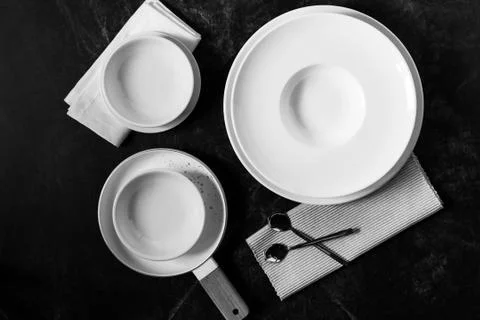 Dinner set on a dark background, Empty white plate with  Fork and Spoon Stock Photos