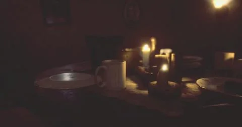 Dinner setting in a dimly lit room with candles and empty plates Stock Illustration