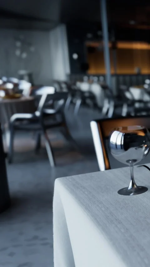 Dinner setting with glasses and tables in a modern restaurant space Stock Footage 337941754