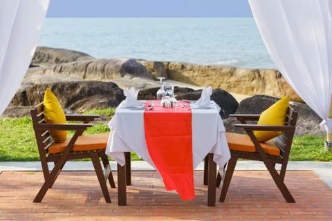 Dinner table beside beach Stock Photos