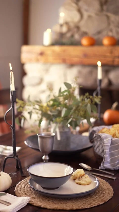 Dinner table decorated for fall and set with dishes, candles and greenery Stock Footage 218266892