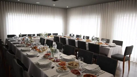 Dinner table for a formal event with clear plates, white napkins, and elegant Stock Footage 337918399