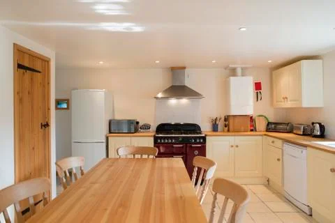 Dinner Table in Kitchen of Posh Vacation House Stock Photos