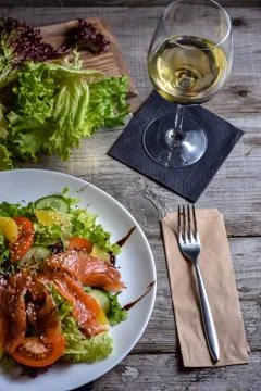 Dinner table for the restaurant client. Fresh fish salad. Stock Photos