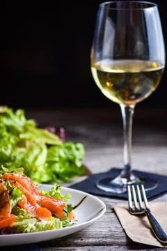 Dinner table for the restaurant client. Fresh fish salad. Stock Photos