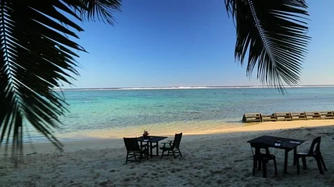 Dinner table set on the beach under the palm tree in exotic Cook Islands. Stock Footage 201602808