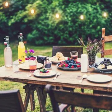 Dinner table set in the garden Stock Photos