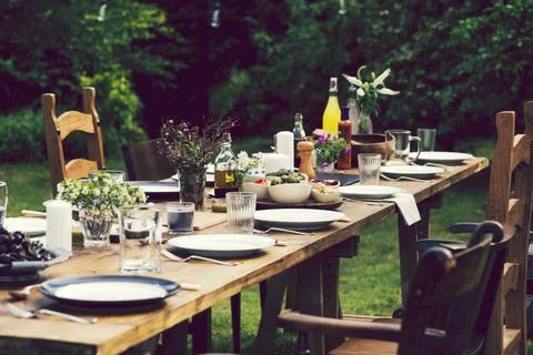 Dinner table set in the garden Stock Photos