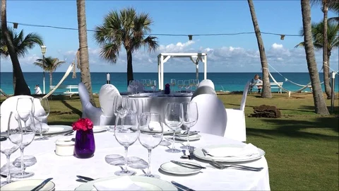 Dinner table set up in a tropical garden on a Caribbean island Stock Footage 104122218