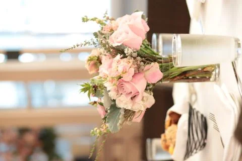 Dinner Table Setting with flowers and candles, soft warm pink peach tones Stock-Fotos